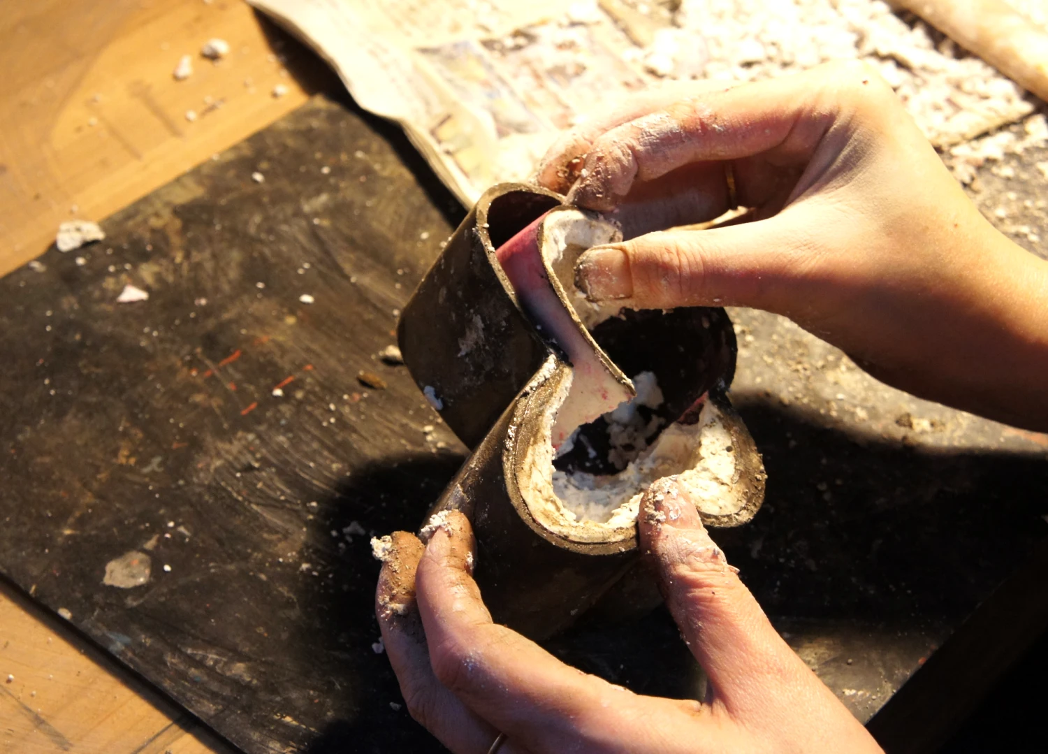Removing the plaster mold from a butterfly-shaped dry lacquer box.