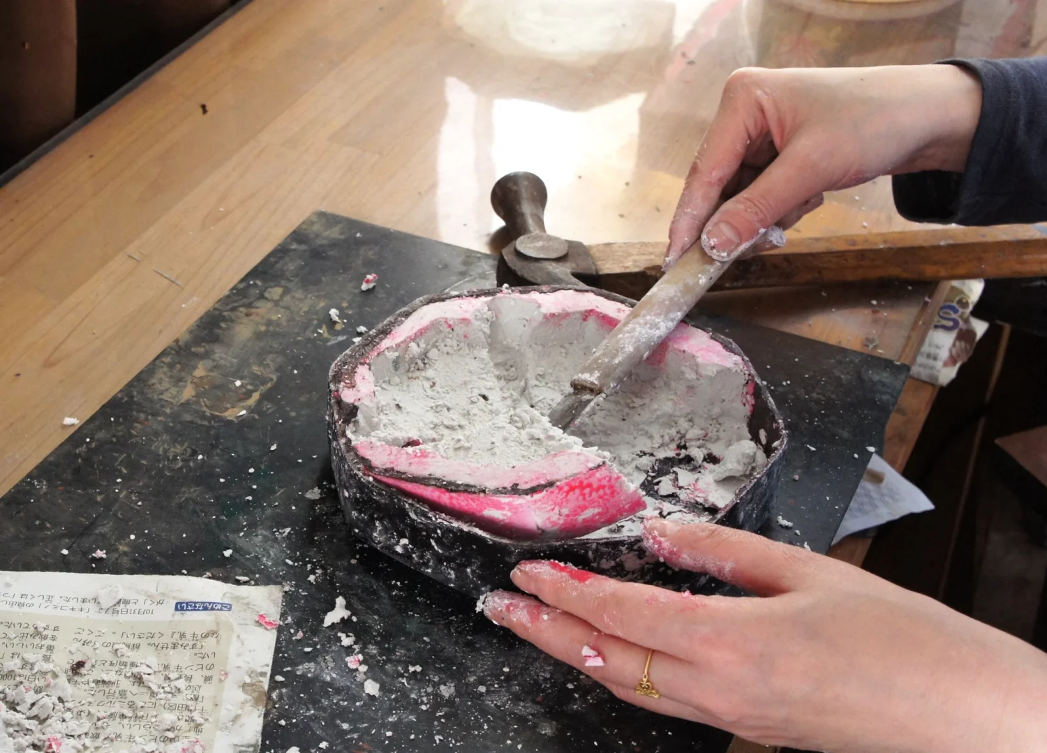 Removing the plaster mold from a butterfly-shaped dry lacquer box.